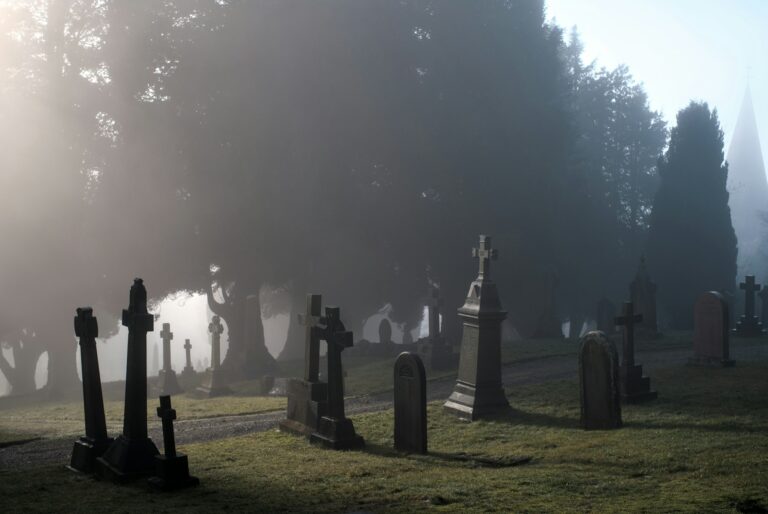 A foggy cemetery in Penrith with gravestones fading into the mist.