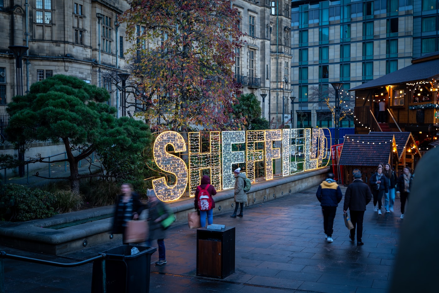 The illuminated Sheffield sign beside Christmas market cabins