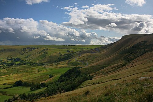 Mam Tor in the Peak District under a wide sky, with the ridge path running away from the camera.